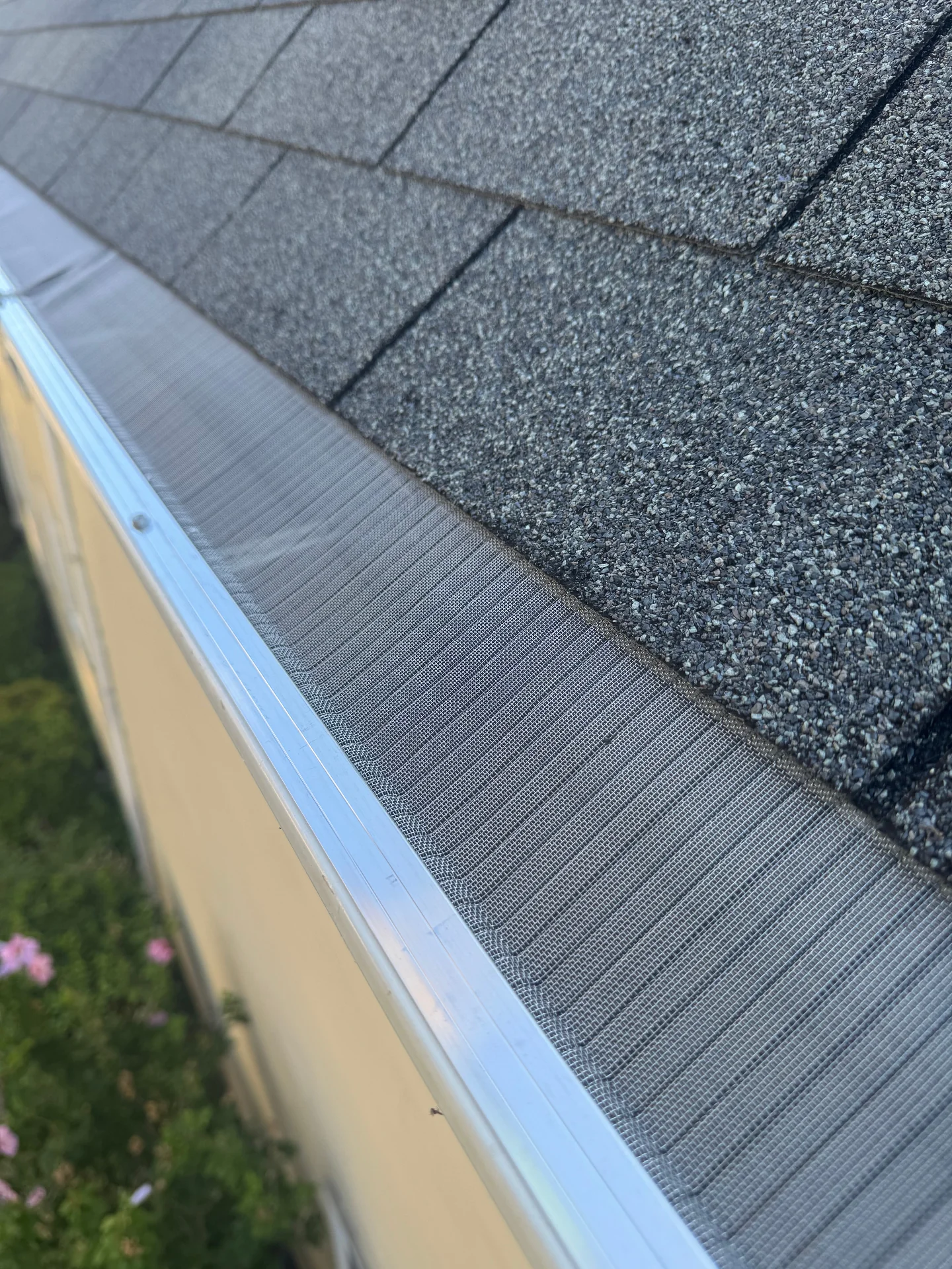 Close-up of professionally installed micro-mesh gutter guard on a modern home roofline